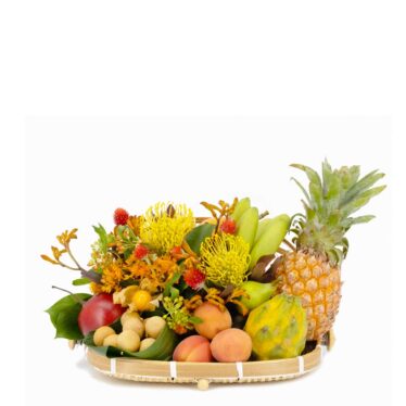 Cesta de frutas tropicales y flores éxoticas